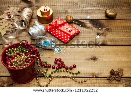 Packaging christmas gifts on dark wooden background top view.