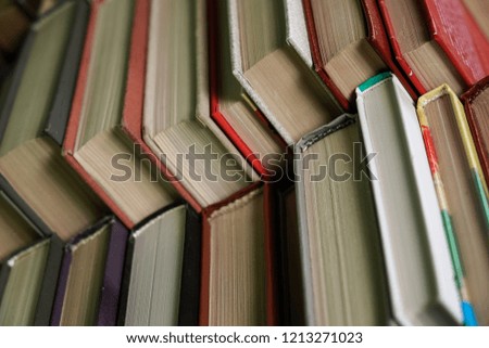 Stack of books background. many books piles. Stack of Books of Different Thickness and Color