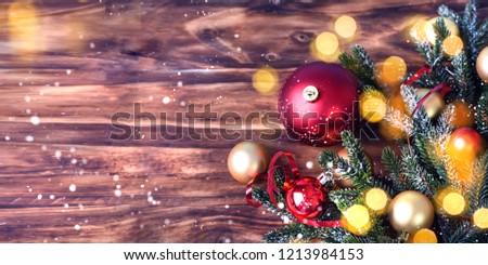 Christmas background with fir tree and decoration on dark wooden board