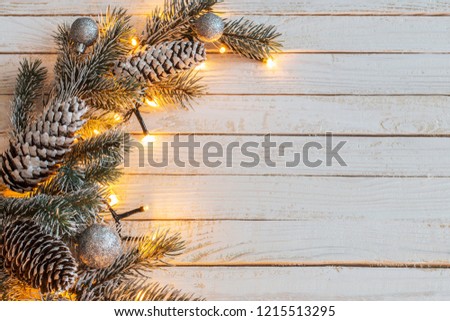 Christmas garland on white wooden background