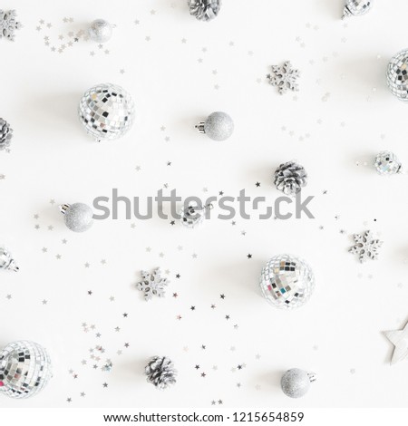 Christmas composition. Christmas silver decorations on white background. Flat lay, top view, square