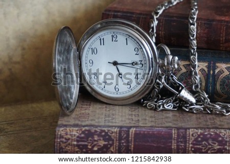 Books and pocket watch with chain