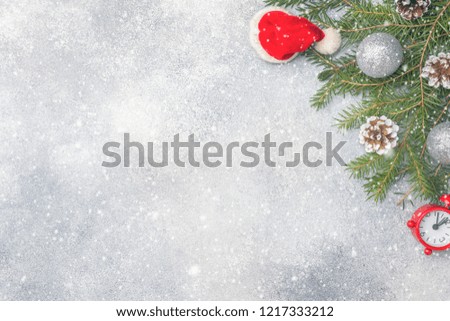 Christmas scenery, toys and branches fir on grey background. New Year concept Copy space.