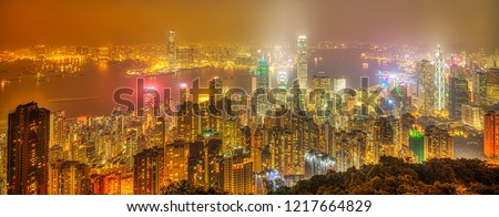 Hong Kong night panorama wide view of Victoria Harbour skyline from Victoria Peak. The Peak is the highest mountain in Hong Kong Island of China.
