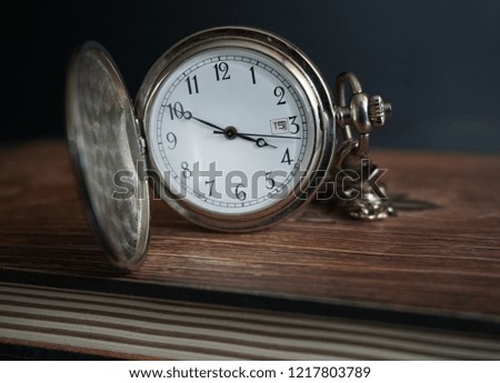 Pocket watch isolated on the notebook