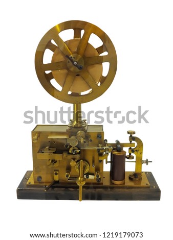 Old ancient telegraph device  on wooden table isolated over white background