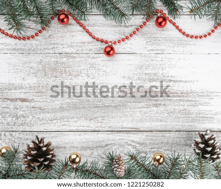 Old wooden Christmas background. Fir branches and cones. Gold and red baubles and garlands. Top view. Space for your text. Xmas card.