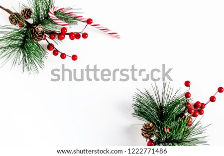christmas tree branch with red balls and candy cane