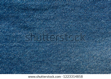 Texture of blue denim without seams and buttons close-up shot.
