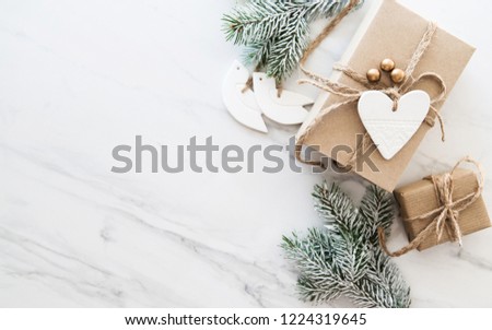 Christmas handmade gift boxes on white marble background top view. Merry Christmas greeting card, frame. Winter xmas holiday theme. Happy New Year. Noel. Flat lay