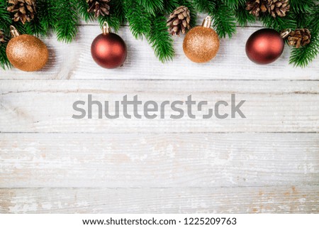 Christmas card. Christmas background with christmas fir tree, pine cones and ornaments. Winter holidays concept. Top view. Copy space