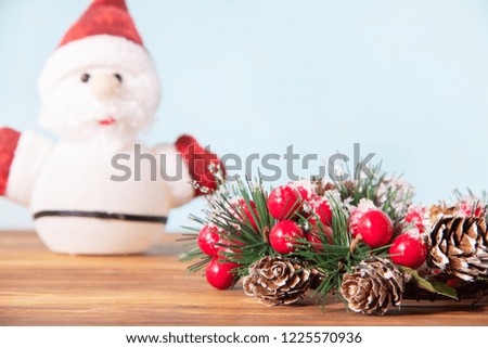 Beautiful Christmas decoration, traditional wreath for the new year for the holiday on wooden background with Santa Claus