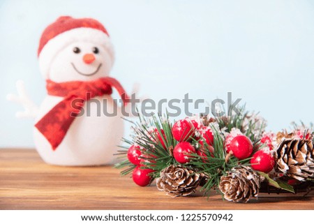 Beautiful Christmas decoration, traditional wreath for the new year for the holiday on wooden background with snowman
