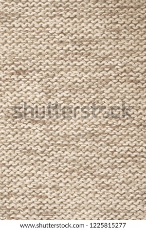 Knitted cloth purl stitch texture of melange neutral colored linen yarn.