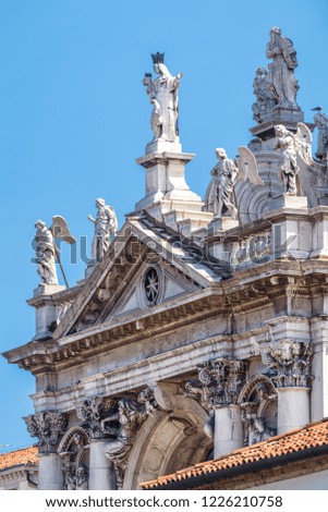 Basilica di Santa Maria della Salute in Venice, Italy. The detail of the facade with statues. Famous church of Salute is one of the main landmarks of Venice. Baroque architecture of Venice close-up.