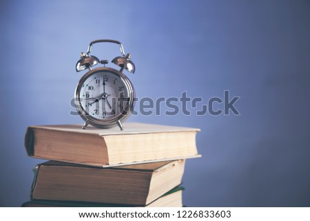 vintage clock on book 