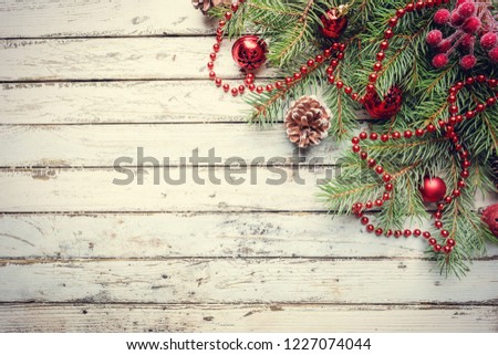 Christmas wooden background with fir tree and decorations. Top view with copy space