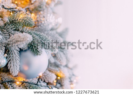 decorated xmas tree on white wall background, close up