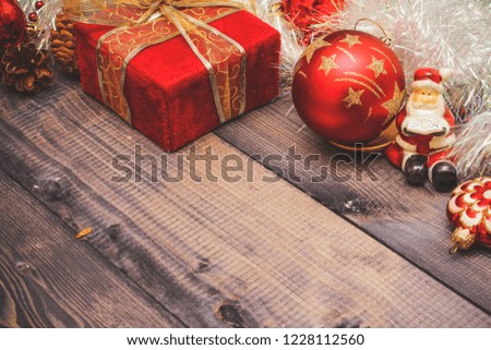 New Year's holiday decor on a wooden table.
Santa Claus and red balls.

