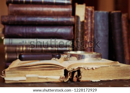 Books shelf with old open book. Old leather bound vintage books