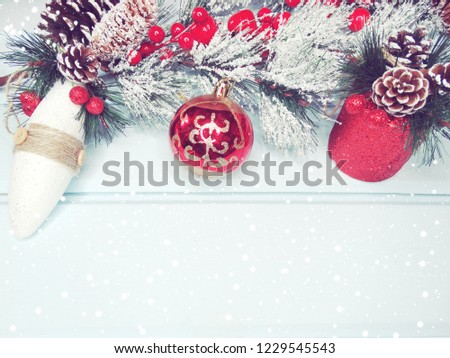 christmas background and decoration with fir branches snow on blue wooden board 