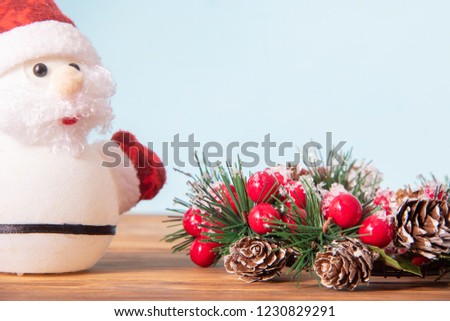 Christmas decoration, beautiful new year wreath for holiday on wooden background with Santa Claus and copyspace