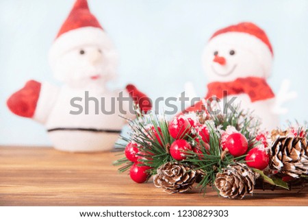 Christmas decoration, beautiful new year wreath for holiday on wooden background with snowman and Santa Claus