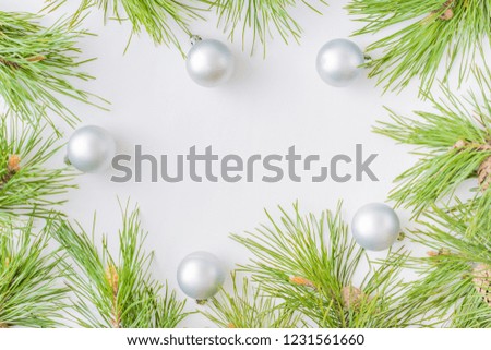 Holiday background with christmas branches and  balls on a light background