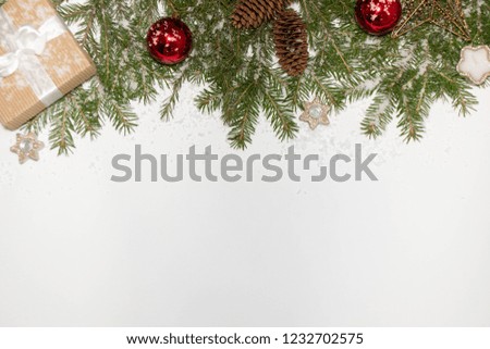 Christmas composition on a white background Fir branches Christmas toys Gift sweets and stars, free space