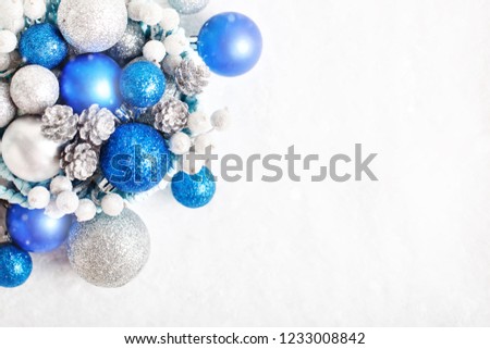 Merry Christmas and happy New year. Blue and silver Christmas toys on a light background. Selective focus. Top view. Christmas background. Background with copy space.