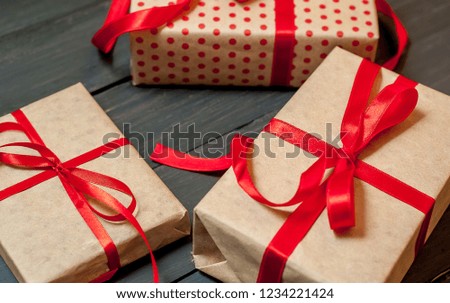 
gifts on a wooden background with a red ribbon