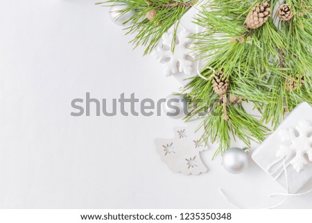 Holiday background with christmas branches and  gift box on a light background