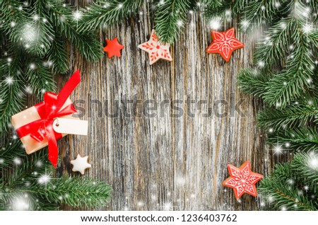 Christmas background with fir tree, gingerbread and gift.