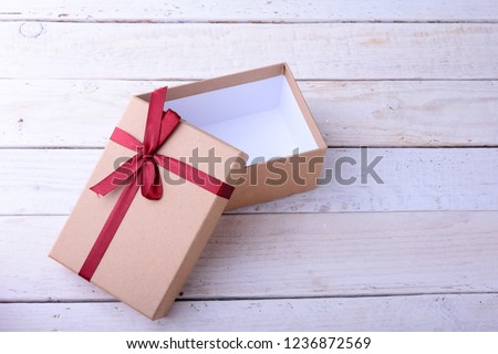 Open Gift boxes with bow on wood background. Christmas Decoration