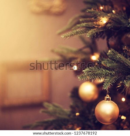 Defocus beautiful dark background. decorations on a Christmas tree and glare of lights