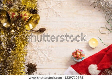 Christmas decorations background with lights, snowflakes, tinsel and bells lie on wooden texture. Top view with empty space.
