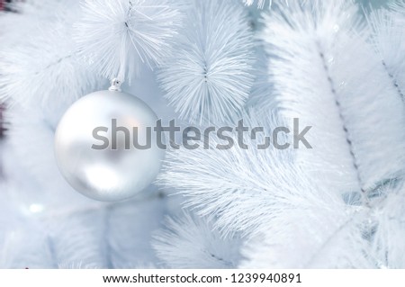 Close-up shots of a Christmas ball in a white Christmas tree