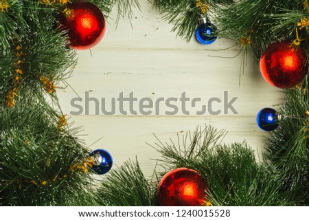 Christmas balls on fir tree branches around copy space