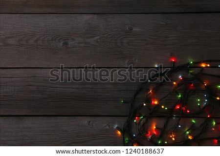 Christmas garland lights on grey background, copy space. Christmas composition