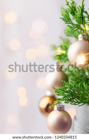 Beautiful Christmas New Year Background. Decorated potted juniper branches ornament balls golden garland bokeh lights. Festive atmosphere. Poster banner flyer template. Shallow depth of field