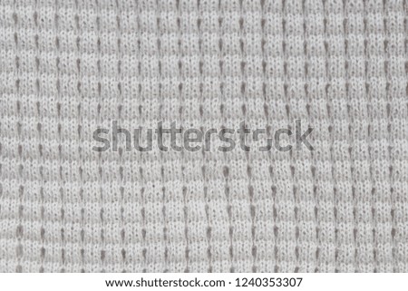 Background textile white knitted cloth pattern of  woolen yarn fabric.