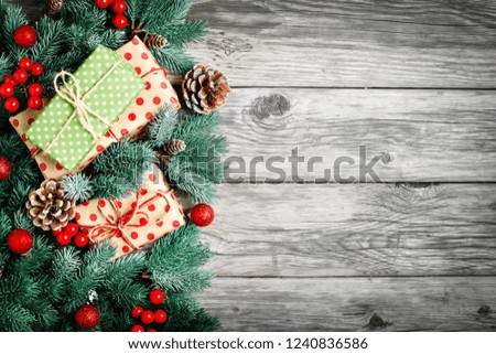 Merry Christmas and happy New year. Spruce branches and Christmas toys on a wooden background. Background with copy space. Top view. Christmas background.