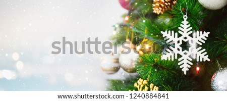 Snow flake decoration ornament on Christmas tree banner background with snowfall,blur bokeh and copy space - can be used for display or montage your products.
