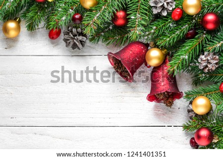 christmas or happy new year background made of fir branches, decorations, red berries and pine cones on white wooden table. Flat lay. top view with copy space