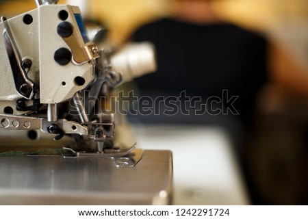 closeup details on sewing machine overlock. Workplace seamstress.Tailoring industry.