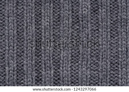 Knitted texture. Pattern fabric made of wool. Background, copy space. Handmade sweater texture, knitted wool pattern, grey background