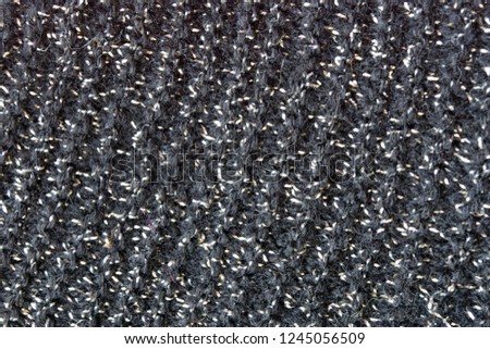 Background. Lurex, silver on a black background. Fabric weaving.