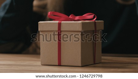 Closeup red ribbon bow on craft gift box