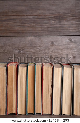 Old vintage books on grey wooden table. Books on rustic background