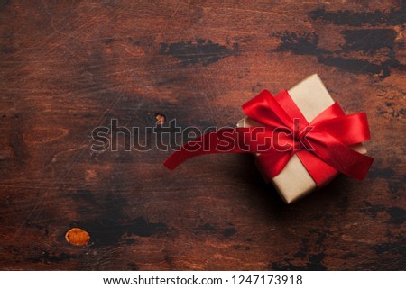 Christmas or Valentine's day gift box on wooden table. Top view with space for your greetings